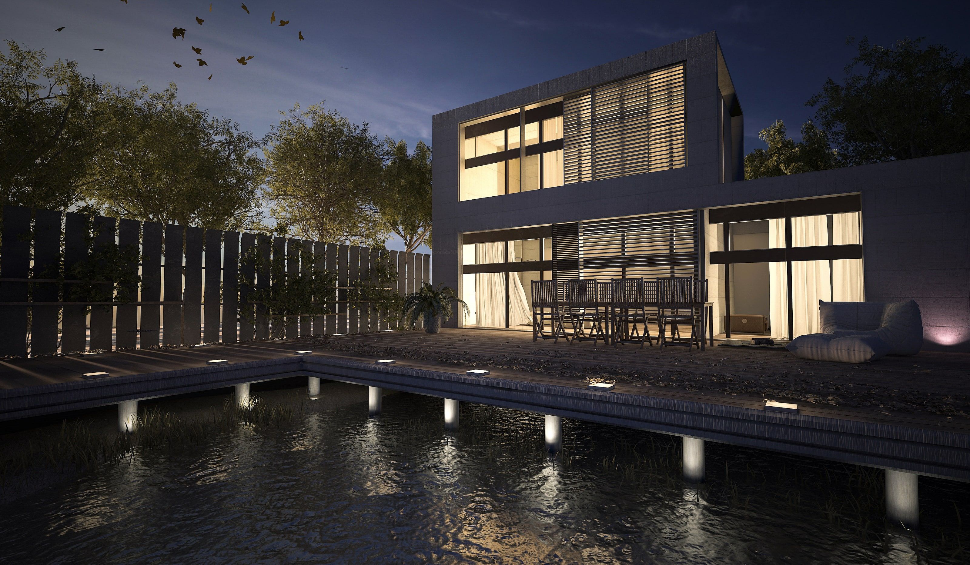 Modernes Wohnhaus mit beleuchteter Terrasse und Pool in der Abenddämmerung